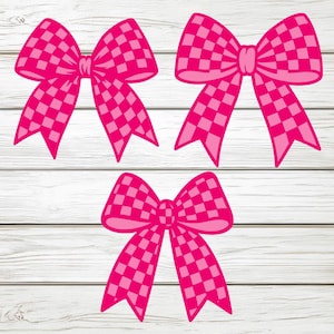 May include: Three pink gingham bows are arranged on a white wood-grain background. The bows have a classic bow shape with long, flowing tails. The gingham pattern is a lighter shade of pink, creating a checkered design.