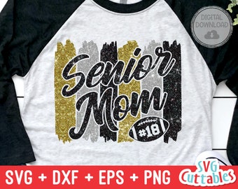 May include: A black, silver, and gold glitter design with the text "Senior Mom" and a football with the number "18" on it. The design is on a white and black raglan t-shirt.