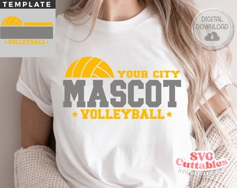 May include: White t-shirt with a gray and yellow design. The design features a volleyball, the text "YOUR CITY MASCOT", and the text "*VOLLEYBALL*"