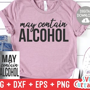 May include: A pink t-shirt with the text "may contain ALCOHOL" in black lettering. The shirt is on a white wooden background with a mug that says "MAY contain ALCOHOL" and a pair of white sneakers.