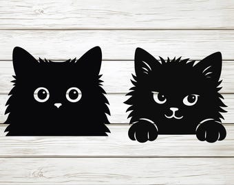 May include: Two black cat silhouettes with white eyes and noses. One cat has a simple design, while the other has paws and a more detailed face. The cats have fluffy fur and are set against a white wood background.