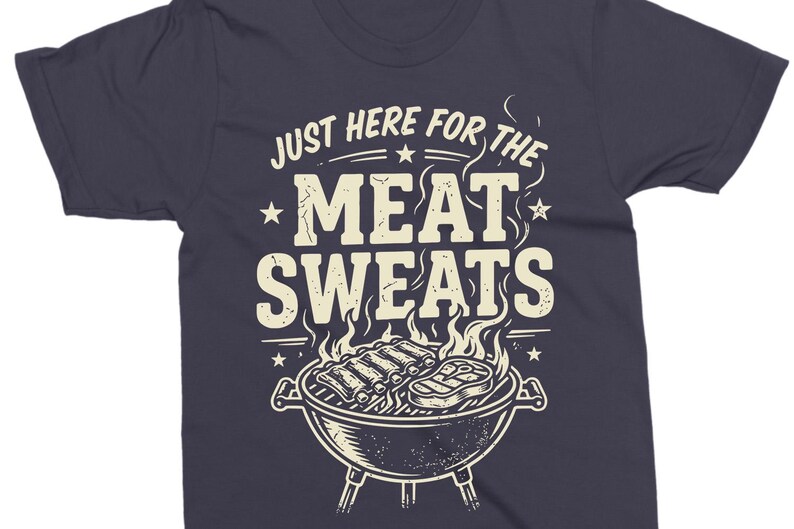 May include: Dark navy blue t-shirt with a barbecue grill graphic. The text "JUST HERE FOR THE MEAT SWEATS" is printed above the grill. The grill contains ribs and a steak, with flames and smoke.