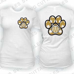 May include: White t-shirt with a gold glitter paw print with a monogram in the center. The back of the shirt has a larger gold glitter paw print with a monogram in the center.