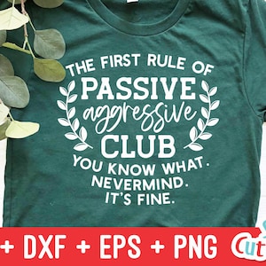 May include: A green t-shirt with white text that reads "The First Rule of Passive Aggressive Club You Know What. Nevermind. It's Fine."