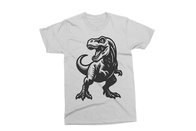 May include: White t-shirt featuring a black graphic of a Tyrannosaurus Rex. The dinosaur is depicted with an open mouth, showing teeth, and is in a standing pose. The shirt is made of a soft material.
