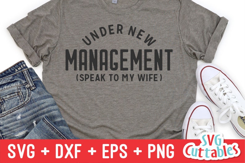 May include: A gray t-shirt with the text "Under New Management (Speak to My Wife)" printed in black.
