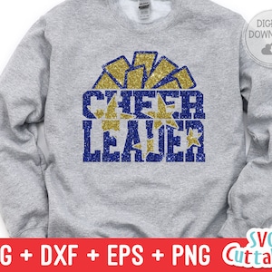 May include: A gray sweatshirt with a blue and gold glitter design that says "Cheer Leader".