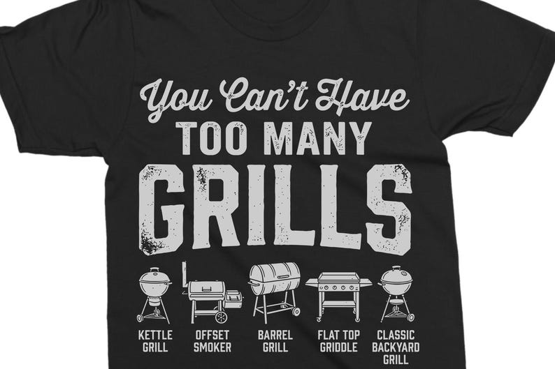 May include: Black t-shirt with the text "You Can't Have Too Many Grills" in white, along with illustrations of different grill types: kettle, offset smoker, barrel, flat top griddle, and classic backyard grill.