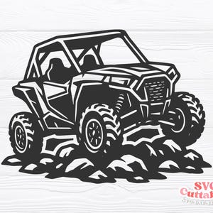 May include: Black and white SVG cut file of an off-road vehicle, with large tyres and a roll cage. The vehicle is shown on a rocky terrain. The SVG Cuttables logo is in the bottom right corner.