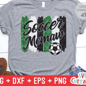 May include: A gray t-shirt with a green, white, and black glitter design that says "Soccer Mama". A soccer ball is included in the design.