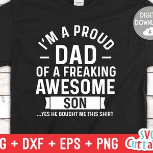 May include: Black t-shirt with white text that reads "I'm a proud - Dad - of a freaking awesome son...yes he bought me this shirt".