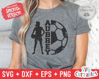 May include: A black and white design featuring a soccer ball and a silhouette of a female soccer player with the name "Aubrey" written vertically beside the ball.
