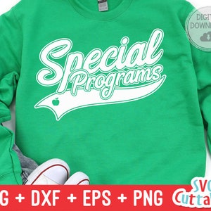 May include: Green sweatshirt with white text that says "Special Programs" with a white apple and a white baseball-style arc above the text.