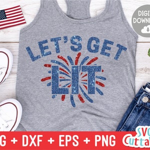 May include: A gray tank top with the text "Let's Get Lit" in blue glitter letters. The text is surrounded by a red, white, and blue firework design.