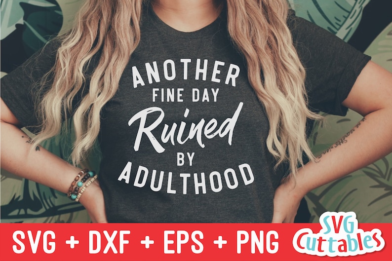 May include: A dark grey t-shirt with white text that reads "Another Fine Day Ruined By Adulthood".