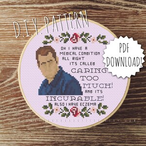 Puede incluir: Un aro de bordado de punto de cruz morado y blanco con una imagen de dibujos animados de un hombre y el texto "Oh I have a medical condition all right. It's called Caring Too Much! And it's Incurable! Also I have eczema."