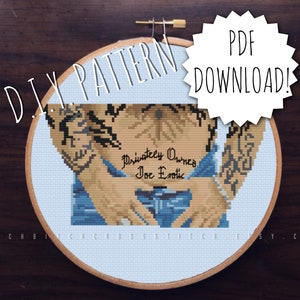 May include: A cross-stitch pattern of a man with tattoos, wearing blue jeans. The text "Privately Owned Joe Exotic" is visible on the pattern.