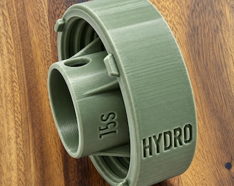 May include: A sage green, cylindrical plastic adapter featuring a central tube with the embossed text 15S and an outer ring with the embossed text HYDRO. The component has a threaded interior and structural support fins connecting the inner and outer sections.
