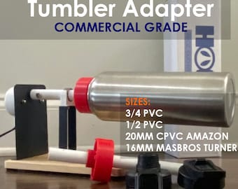 Peut inclure: Adaptateur de gobelet HOGG DUO HYDRO COMMERCIAL GRADE avec un gobelet en métal argenté, des inserts en plastique rouge et des couvercles noirs. Le texte indique les tailles : 3/4 PVC, 1/2 PVC, 20MM CPVC AMAZON, 16MM MASBROS TURNER. Inclut une boîte blanche.