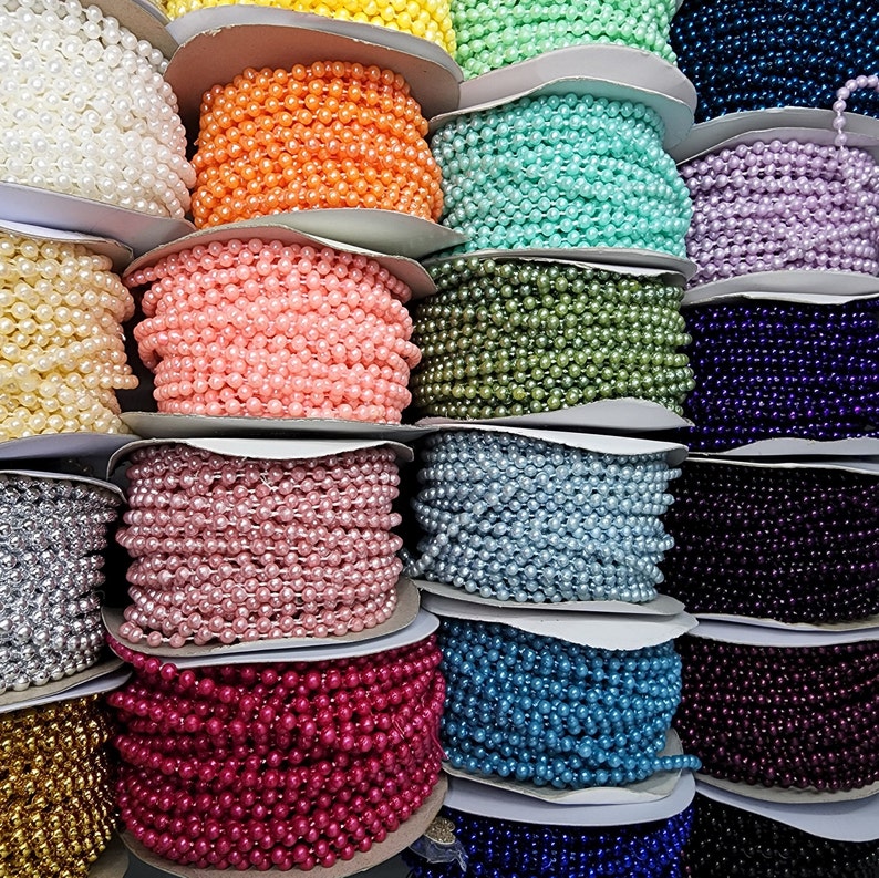 May include: A collection of multiple spools of faux pearl bead strands in a wide variety of colors including white, yellow, orange, mint green, pink, peach, olive green, lavender, silver, gold, light blue, dark blue, purple, and black.