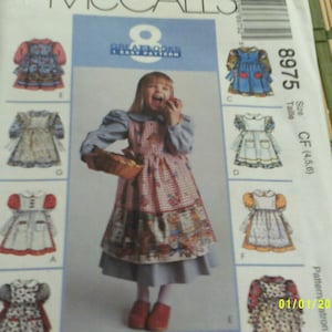 McCalls 8975 Girls dress and pinafore pattern. Size 4-6