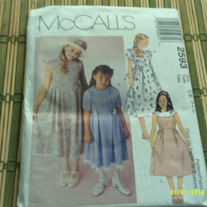 May include: A sewing pattern for three girls' dresses. The pattern is McCall's 2593 and includes instructions for making a sleeveless dress with a gathered skirt, a short-sleeved dress with a gathered skirt and a lace trim, and a sleeveless dress with a gathered skirt. The pattern is for sizes CE (3-4-5).