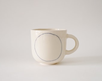 Handmade Ceramic mug with blue circle H: 3″