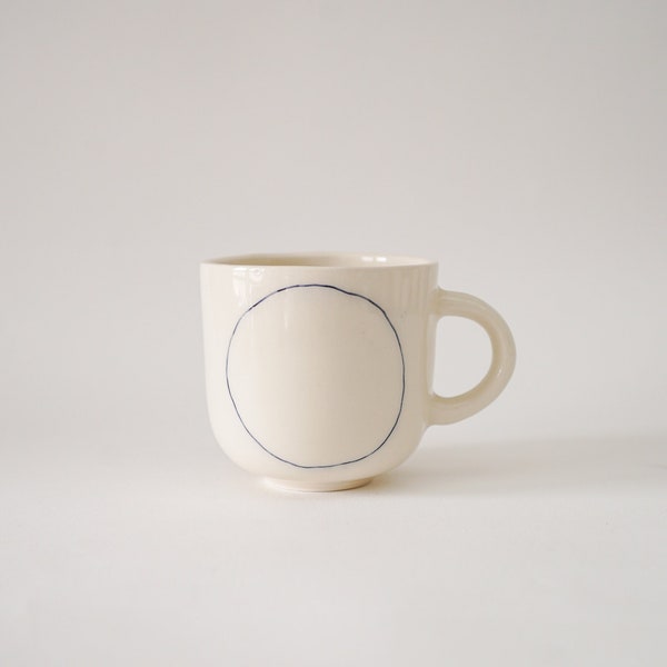Handmade Ceramic mug with blue circle H: 3″