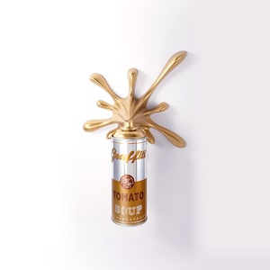 May include: A gold-colored spray paint can with a gold splash design. The can is labeled "Tomato Soup" in gold lettering. The word "Graffiti" is also visible on the can.