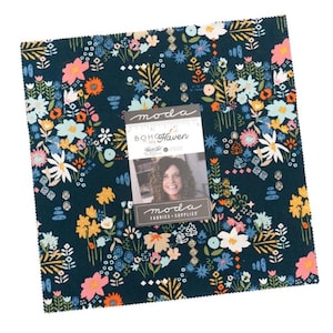 May include: A square fabric piece with a dark teal background, covered in a floral pattern with pink, white, yellow, and blue flowers. A tag reads "BOH Haven" and "moda FABRICS + SUPPLIES".