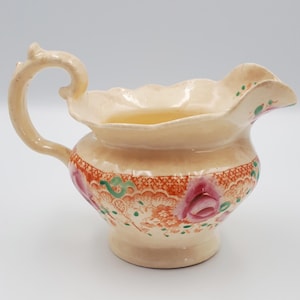 Antique floral jug. Porcelain jug with orange and pink floral decoration. Very pretty!
