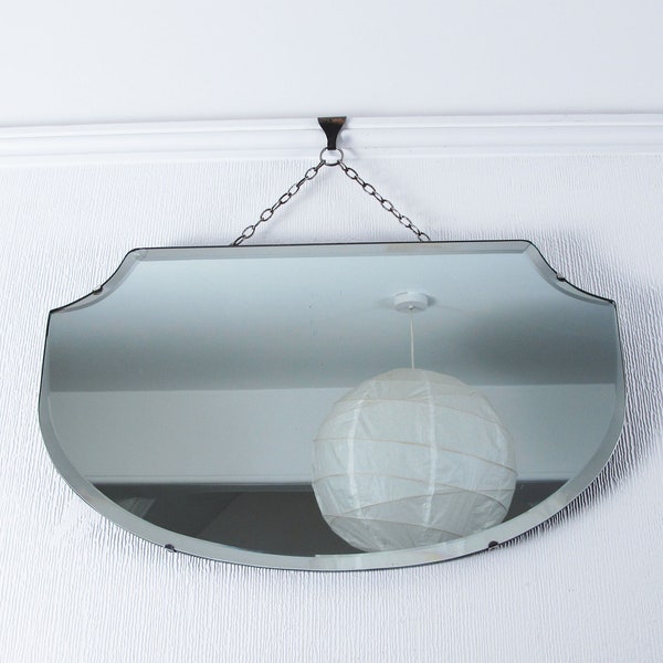 Art Deco mirror. Bevelled edge frameless wall mirror with original visible hanging chain. Lovely curved shape.