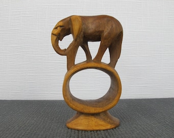Vintage wooden elephant napkin ring. Lovely hand carved elephant, balancing on the top of the napkin ring.