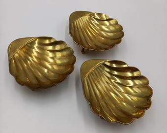Vintage set of three shell shape footed dishes. Gold tone metal