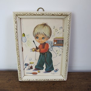 Vintage big-eye boy framed print by Hugeles. Boy about to plug in his radio to the light socket! Danger!! 6.5 x 4.75 inches (17 x 12cm)