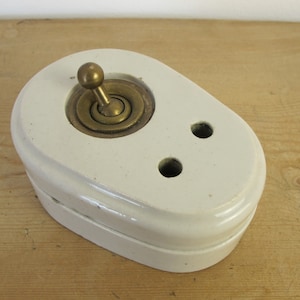 Vintage switch.Brass and ceramic. Made in England - two pin electical socket and brass on/off switch