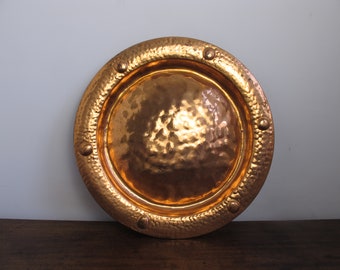 Vintage copper tray or wall plaque. Round tray with simple hammered and raised dot decoration. 17 inches (43cm) diameter