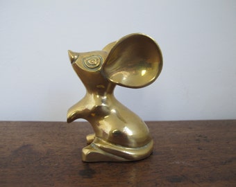 Brass mouse with very big ears. Loves cheese. Quizzical look.