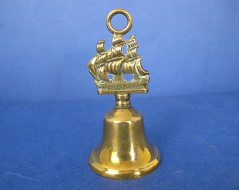 Vintage brass hand bell with HMS Victory handle. Lovely sound! 12cm tall.