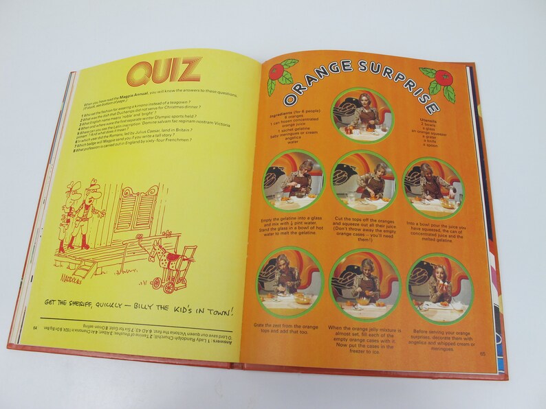 May include: Open book with a yellow page featuring a quiz and a cartoon illustration. The opposite page has an orange-themed recipe titled "Orange Surprise" with step-by-step photos and instructions.