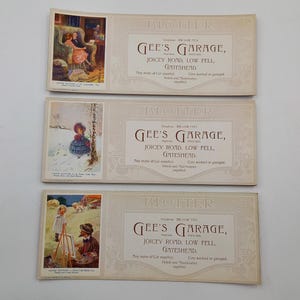 May include: Three vintage blotters with illustrations and text for Gee's Garage. Each blotter displays a different scene: a couple in a room, a girl in the snow, and an artist painting. The text includes the garage's name, address, and services.