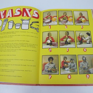 May include: Open book page with instructions for making masks. The title "MASKS" is in red and yellow. Step-by-step photos show the process, with text describing each stage. Includes illustrations of materials like flour and a balloon.