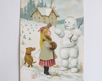 Vintage Christmas postcard - girl with Dachshund and snowman - snowy festive scene