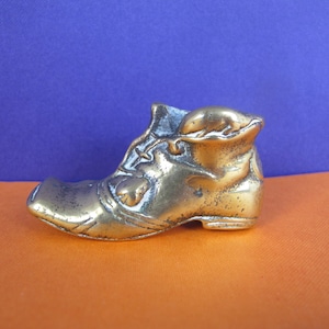 Small brass boot. Vintage brass match holder in the shape of a boot.