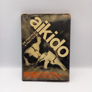 The Principles and Practice of Aikido by Senta Yamada and Alex Macintosh, first edition 1966. Vintage martial arts book