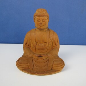 Vintage wooden Buddha statue. Hand carved solid wooden sculpture.
