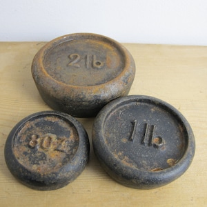 Antique weights. Three cast iron weights - 8oz, 1 lb and 2lb. Round weights for balance scales