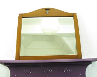 Vintage wooden framed bevelled mirror. Rectangular mirror with curved frame and cut-out detail - ready to hang.