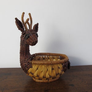 Vintage basket. Small rattan oval basket with adorable reindeer or antelope head. Boho interiors.