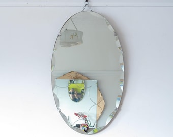 Art Deco Oval frameless Mirror. Scalloped bevel, shell clips, original visible chain